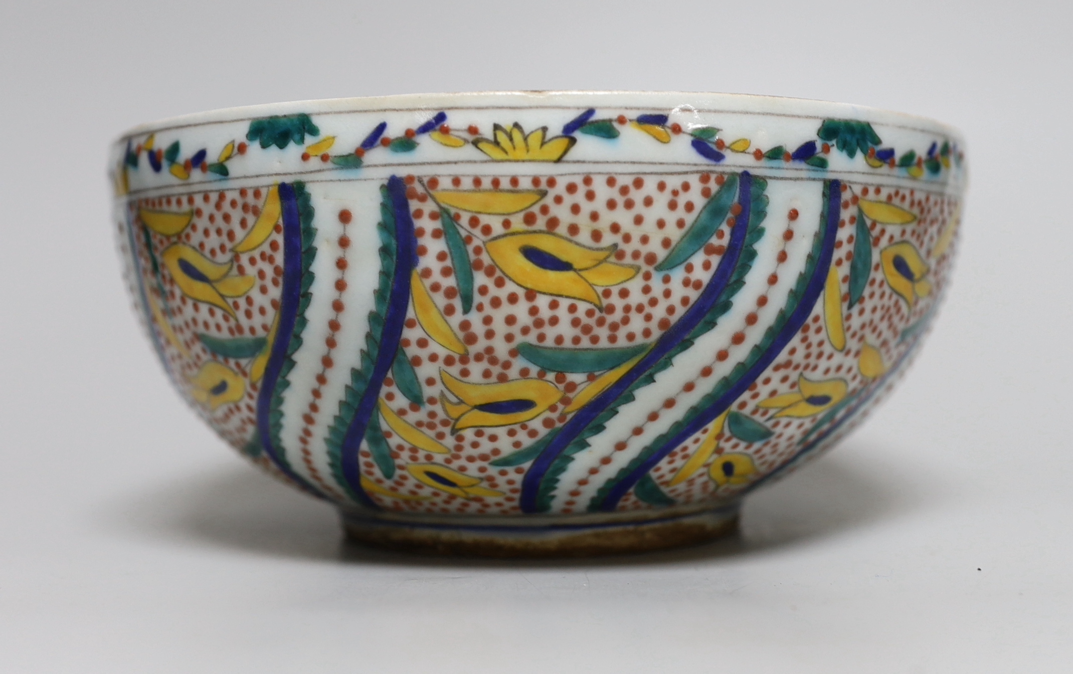 A Turkish Kutahya bowl hand painted with stylised flowers, 19cm in diameter